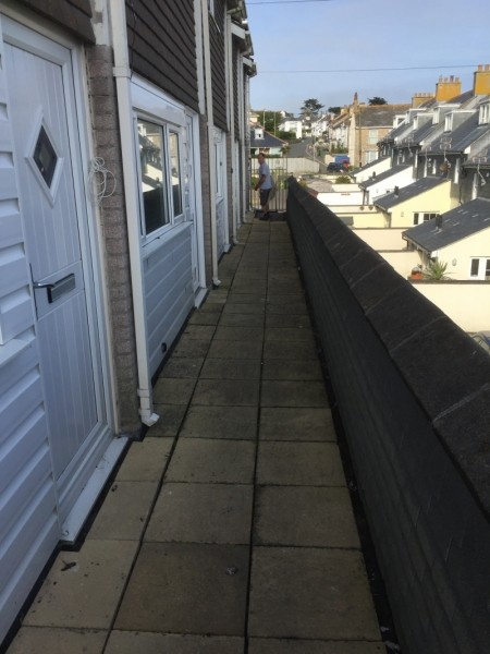 Paved balcony walkway in front of houses
